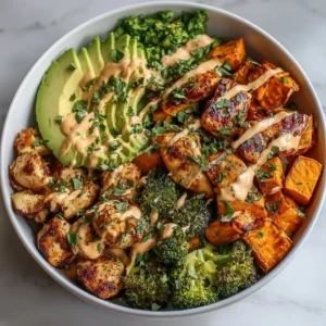 Healthy chicken rice bowl with sweet potatoes and fresh vegetables